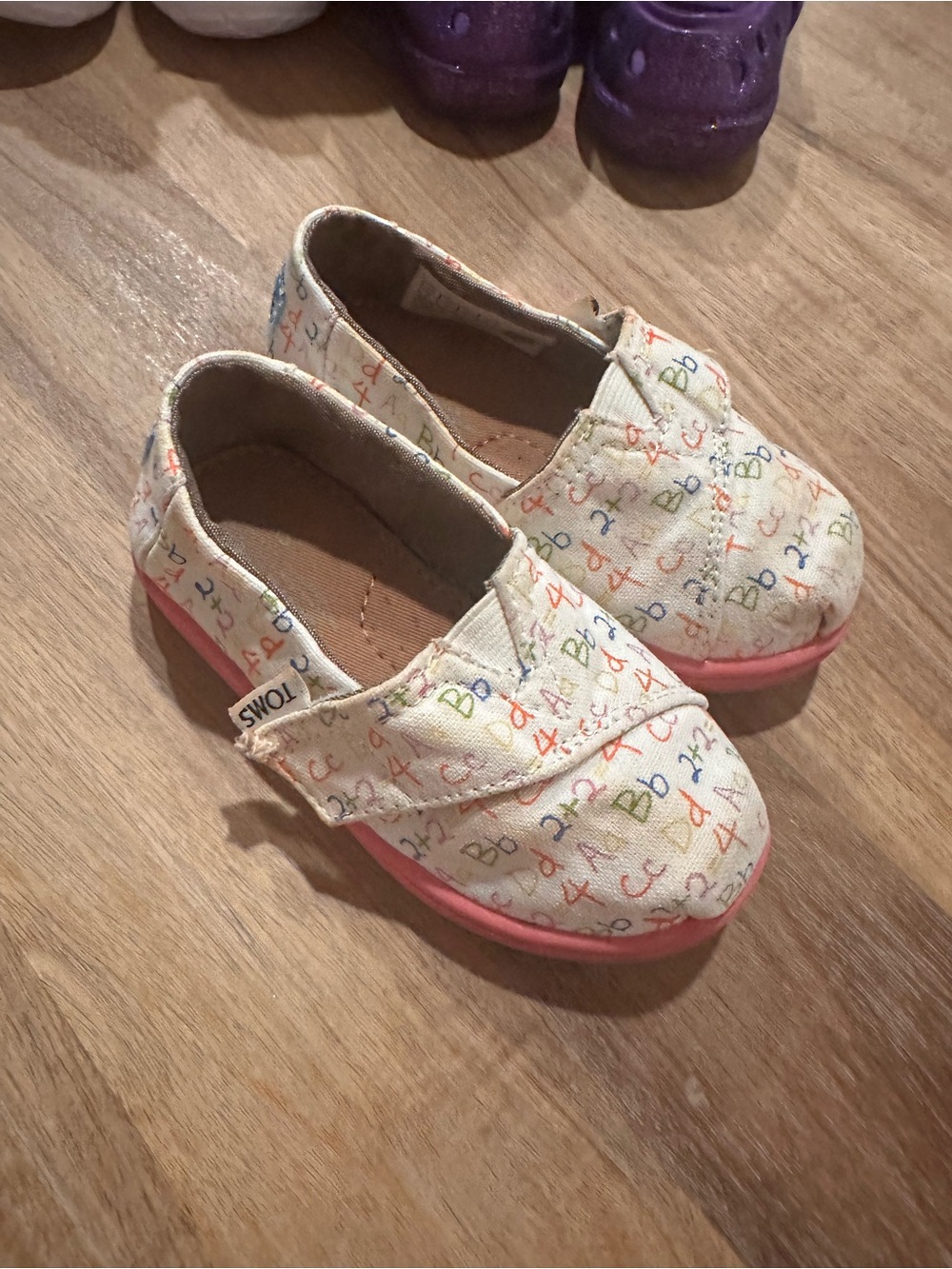 TOMS Kids Canvas Slip-On Shoes in Cream with Pink Sole and Multicolor Print